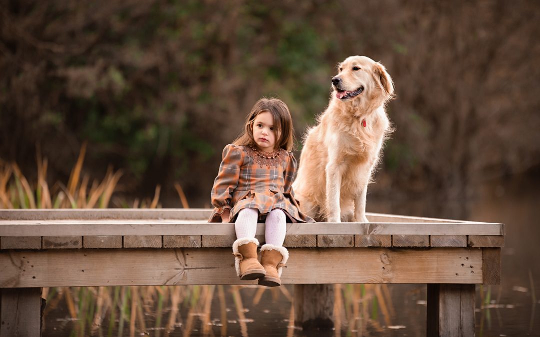 Family photographer in Barnsley, little girl by the lake with her dog
