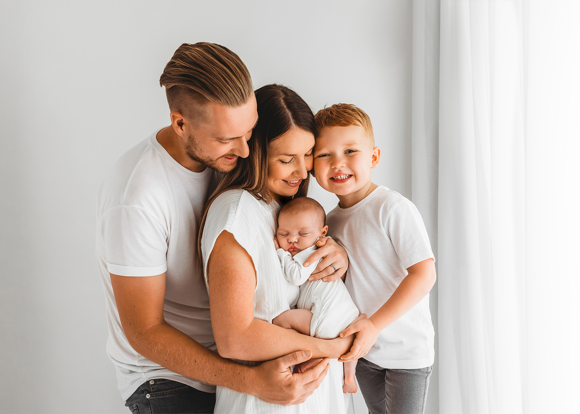 Barnsley photographer, parents cuddling newborn daughter and son