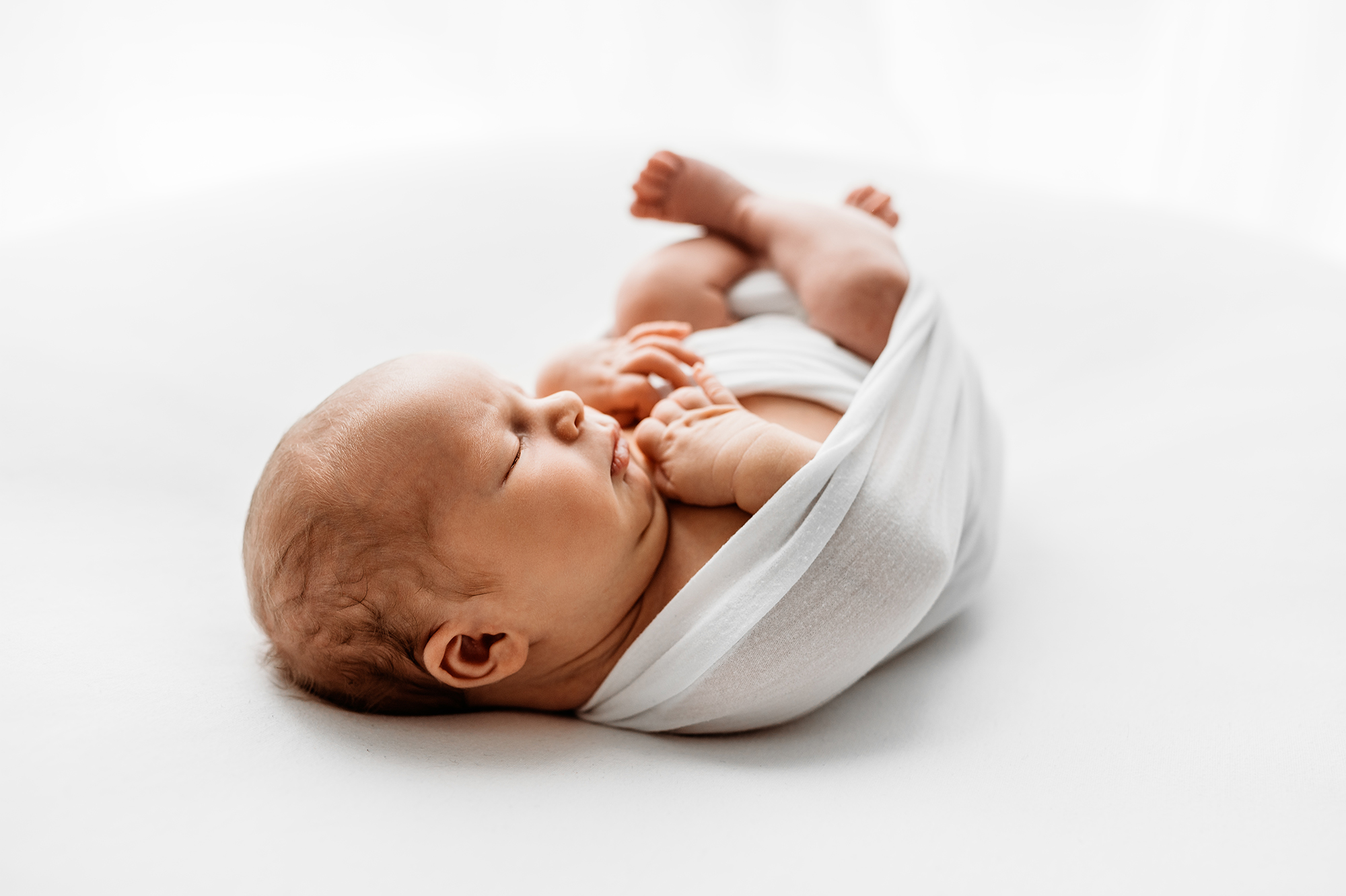 Barnsley newborn photographer, baby wrapped up in a wrap 