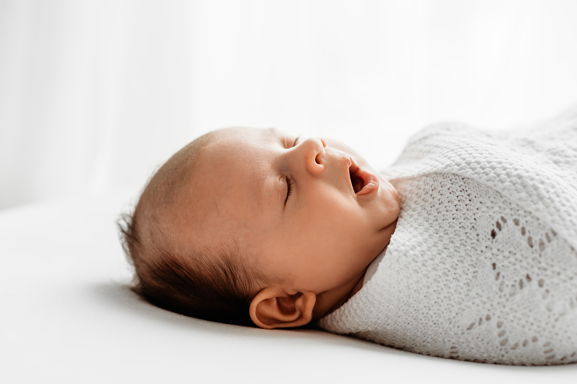 baby yawn in older newborn photography shoot