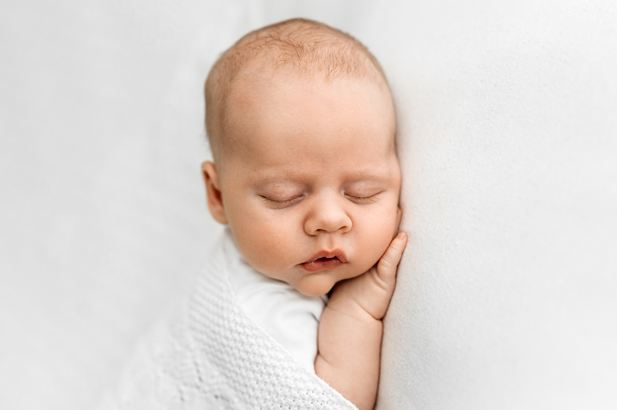 older newborn sleeping during photography session