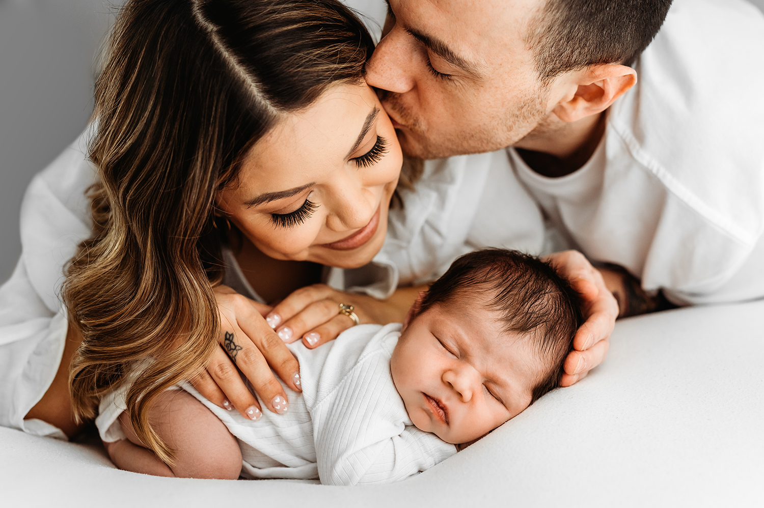 Barnsley newborn photographer, family cuddling sleeping baby
