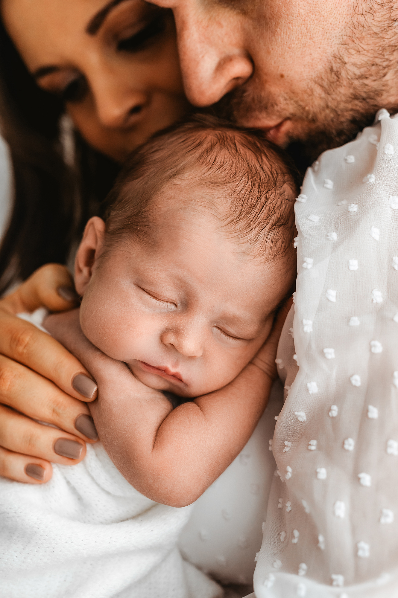 close up of baby in parents arms, how to choose a newborn Photographer