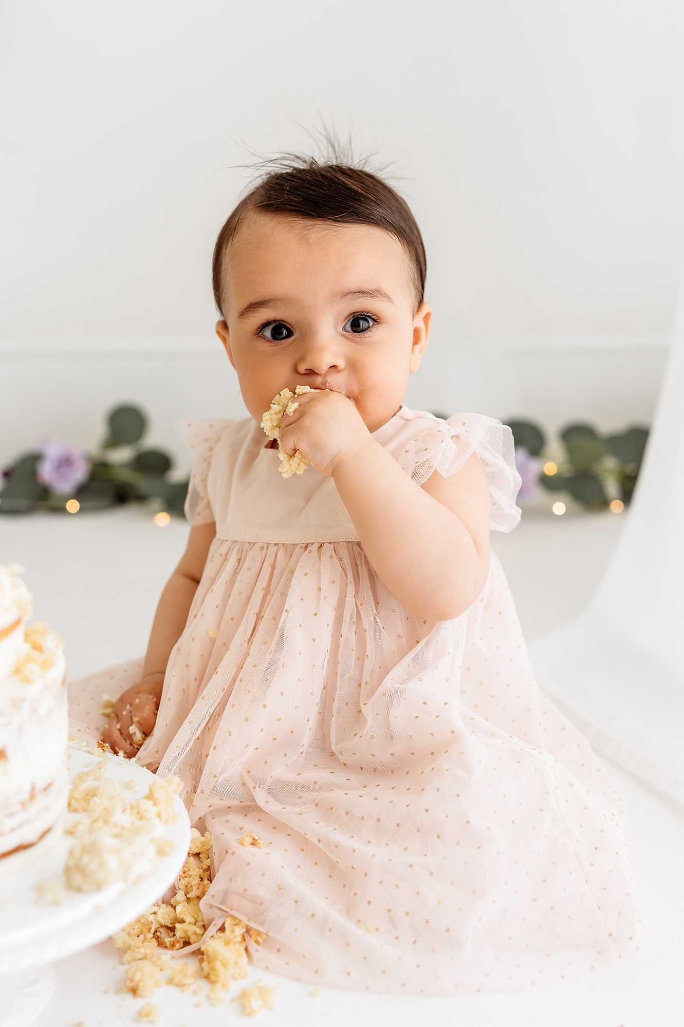 photoshoot with mamas & papas - baby girl taking a lot of cake
