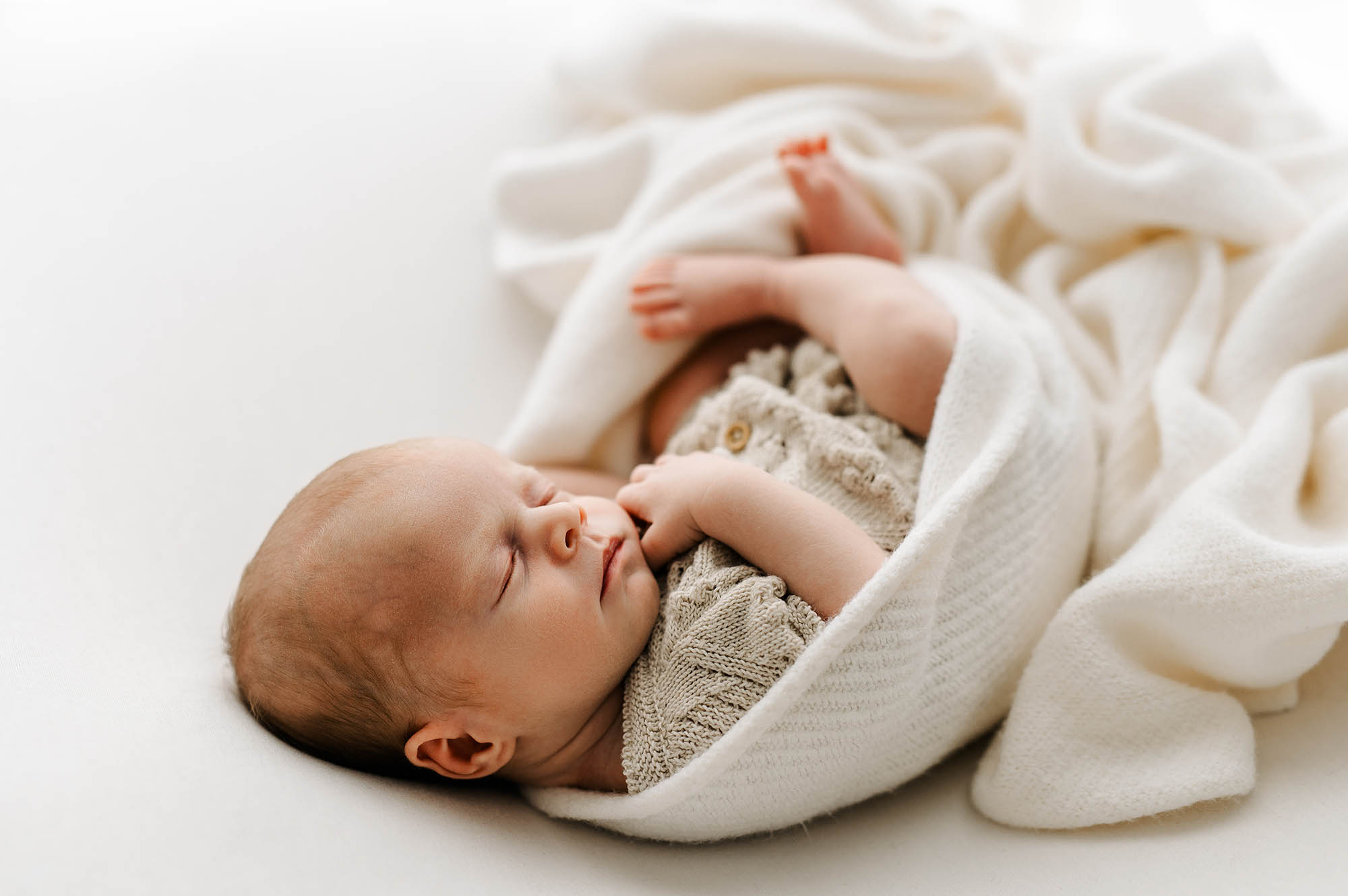 Baby in cosy knits with newborn photographer Barnsley
