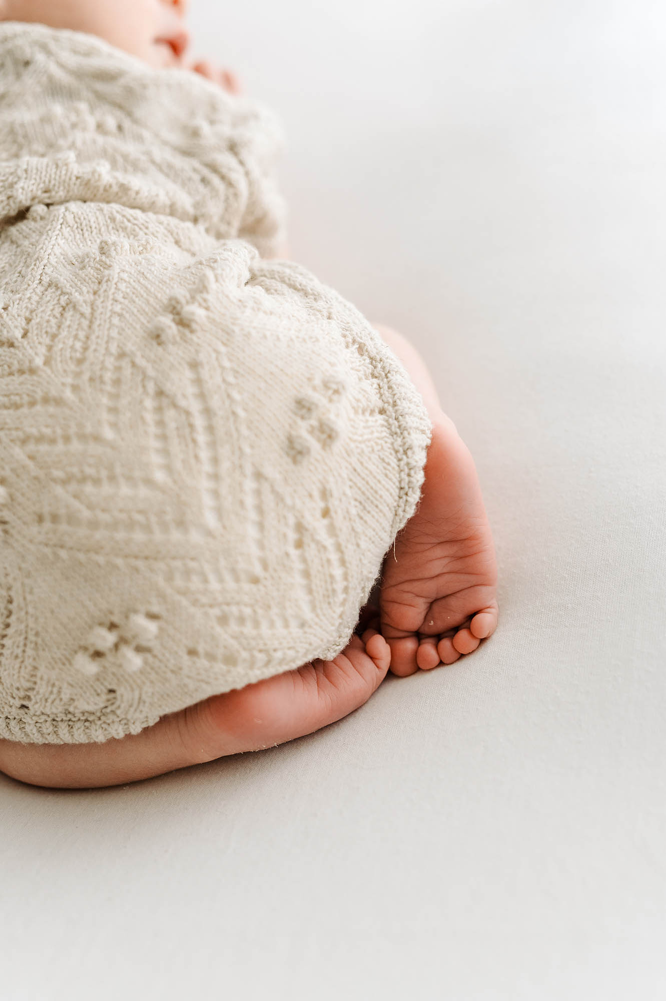 Baby feet close up in a knitted romper