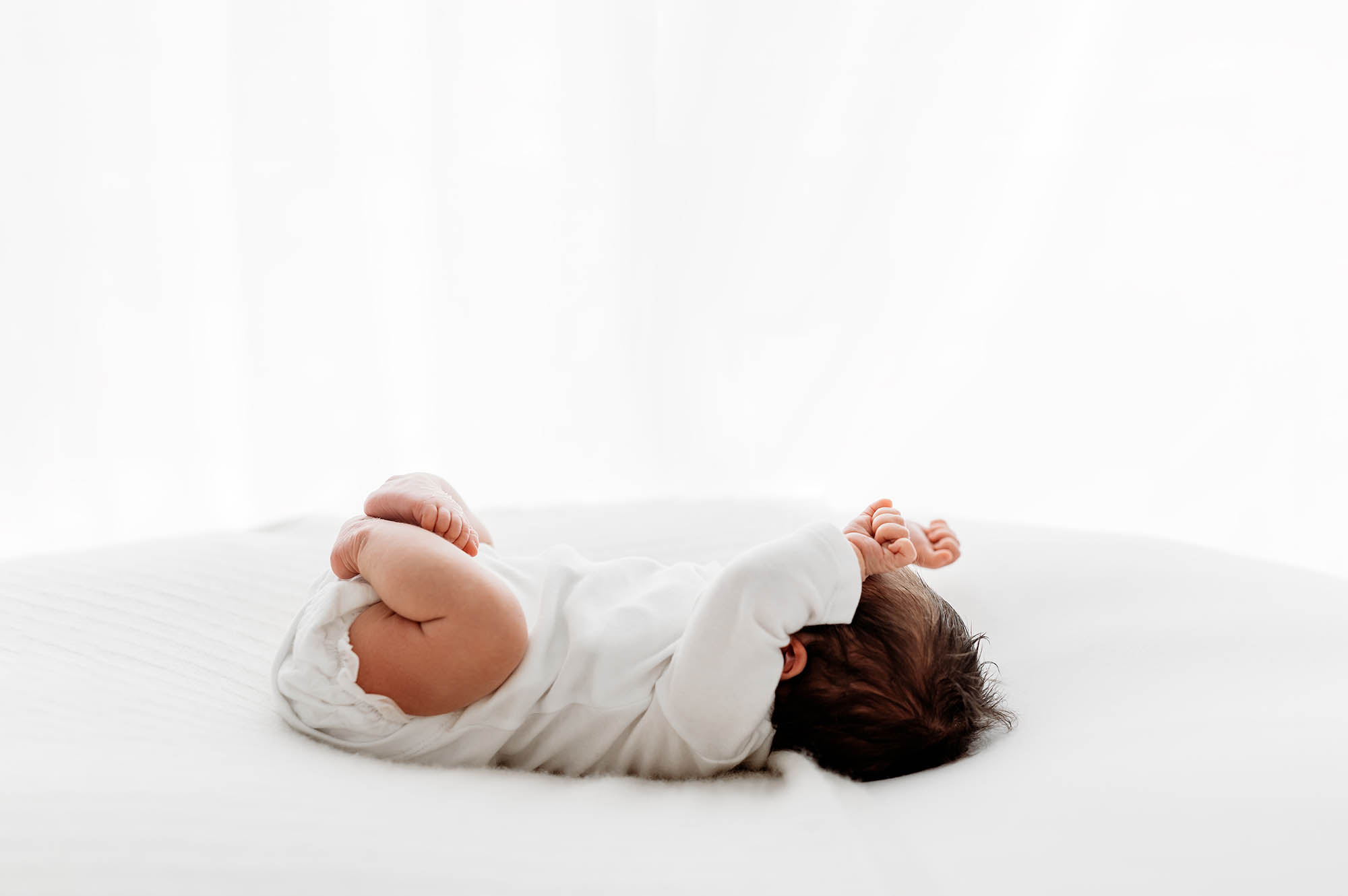 Baby stretching at newborn photography in Barnsley
